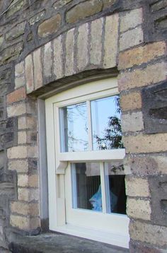 an old brick building with a white window