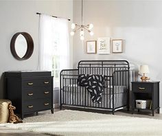 a baby's room with a crib and dresser