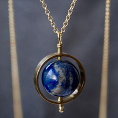 "Lapis Lazuli and Brass Save The Planet Fidget Long Statement Pendant Necklace Great gift idea for anyone to send a little message with a story to raise awareness of protecting our beautiful planet Earth. I will donate 10% of sales to Greenpeace UK.  I first encountered the word \"Spaceship Earth/Spaceship Planet Earth\" by my high school teacher in Japan in 1994. This idea is a worldview encouraging everyone on Earth to act as a harmonious crew working toward the greater good. Which means we lo Alchemy Jewelry, Fidget Necklace, Planet Necklace, Spaceship Earth, Lapis Lazuli Necklace, Healing Necklace, Symbolic Jewelry, High School Teacher, Greater Good