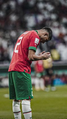 a soccer player is standing on the field