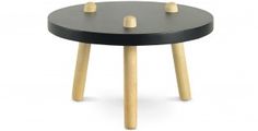 a small black table with wooden legs and knobs on the top, in front of a white background