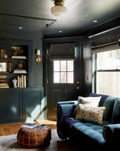 a living room filled with furniture and bookshelves