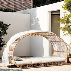 a white couch sitting on top of a wooden floor next to a pool