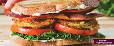 a sandwich with bacon, lettuce and tomato