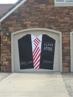 a couple of garage doors decorated to look like they have ties on them and the words elder stone welcome home