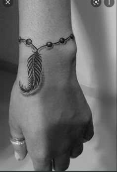 a black and white photo of a person's foot with a feather on it