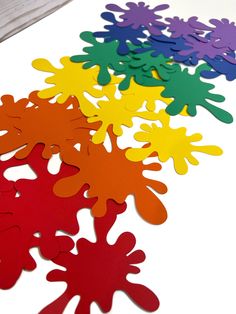 colorful paper cut outs sitting on top of a table