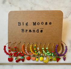 a bunch of earrings that are on top of a card with the words, big moose brand