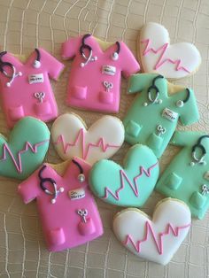 decorated cookies in the shape of medical gowns and heart shaped cookies with stethoscopes on them