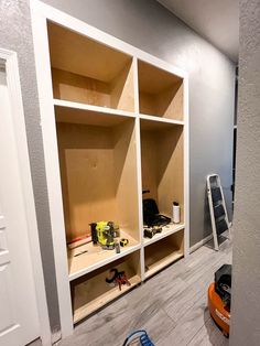 a room with shelves and tools on the floor