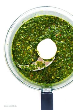 a food processor filled with pesto sauce