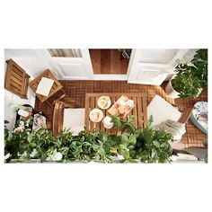 an overhead view of a living room and dining area with potted plants on the floor