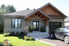 a car is parked in front of a house with stone and wood trimmings