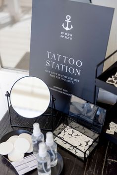 there is a tattoo station on the table next to it's mirror and other items