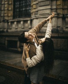 a man and woman dancing on the street