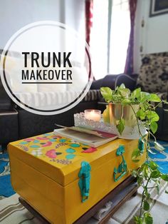 a trunk that is sitting on top of a table next to a potted plant