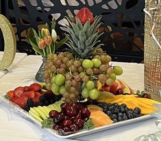 a platter filled with fruit on top of a table