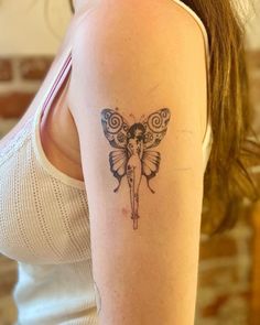 a woman with a butterfly tattoo on her arm