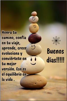 some rocks stacked on top of each other with the words happy birthday written in spanish