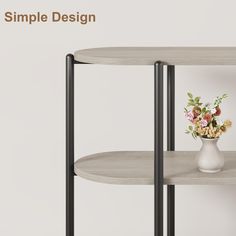 a white vase with flowers sitting on top of a table next to a black metal shelf