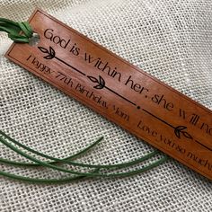 a wooden bookmark that says god is within her she will always be with you