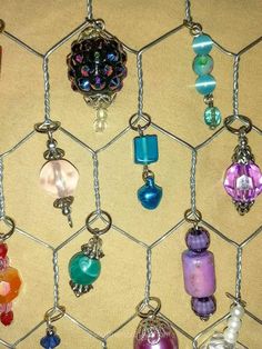 a bunch of different colored beads hanging on a chain