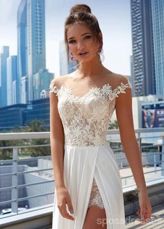 a woman in a white dress posing for the camera