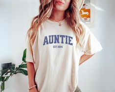 Orders placed after December 10th may not arrive before Christmas due to high holiday demandAre you looking for auntie gift? We got you! ✅ ABOUT OUR Custom Aunt to Be Shirt Comfort Color T-shirt  ▸ 100% ring-spun US cotton for long-lasting comfort.  ▸  The garment is sewn around the finished edges with double stitching, making it long-lasting ▸  The garment is dyed after it's been constructed, giving it a soft color and texture ▸ Printed and shipped from the USA ✅ HOW TO ORDER your Aunt Est Shir Christmas Gift For Aunt, Aunt To Be, Aunt Shirt, Gift For Aunt, Photo Care, Aunt Shirts, Auntie Gifts, Aunt Gifts, Oct 11