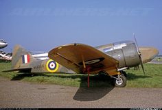 an old airplane is parked on the grass