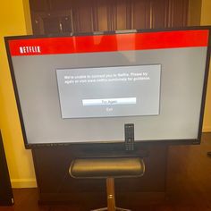 a flat screen tv sitting on top of a wooden table