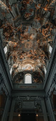 an ornate ceiling with paintings on it in a room that is painted black and white