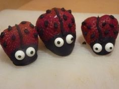 three chocolate covered strawberries with googly eyes