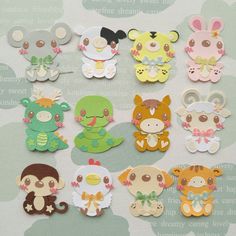 a bunch of cute little animal magnets sitting on top of a table