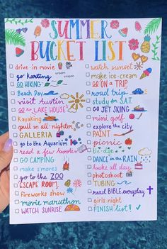 someone holding up a summer bucket list