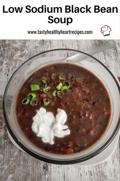 a bowl of black bean soup with sour cream