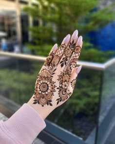 a woman's hand with henna on it