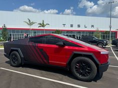 a red sports car parked in a parking lot