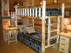 a bunk bed made out of logs in a room