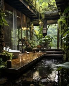 an outdoor bathroom with a large tub next to a wooden deck surrounded by greenery