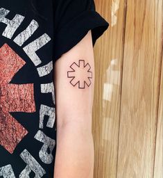 a woman's arm with a tattoo on it that has an arrow in the middle