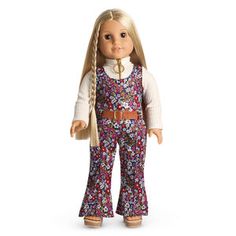 a doll with long blonde hair wearing overalls and a white sweater is standing in front of a white background