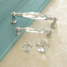 three crystal knobs and two glass door handles