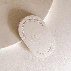 a close up of a white plate with a tag on the front and back of it