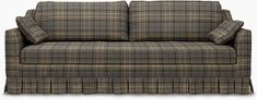 a brown plaid couch sitting on top of a white floor