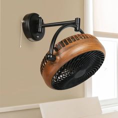 a wooden fan mounted to the side of a wall