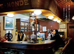 people sitting at a bar in a restaurant