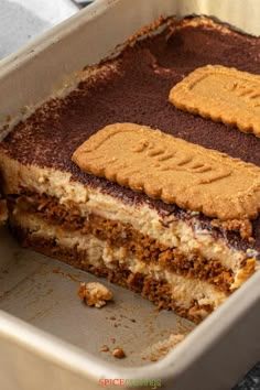 a close up of a cake in a pan with some cookies on top of it