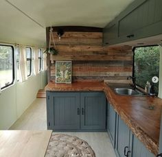 the interior of a mobile home with wood paneling on the walls and counter tops