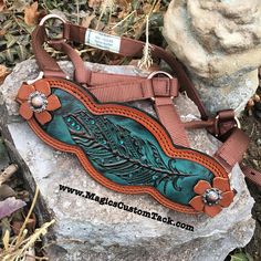 a brown and blue purse sitting on top of a rock