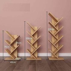 three wooden bookshelves are shown with measurements for each shelf in front of the wall